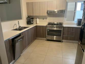 Large covered terrace with outdoor seating and garden in family home for rent in Panama Pacifico