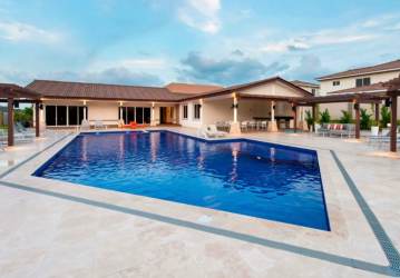 Residents swimming pool with sun loungers and pergolas in Woodlands Bosques del Pacífico Panama Pacifico