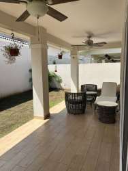 Bright guest bedroom with neutral walls, AC unit, window blinds in Panama Pacifico rental house