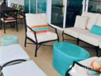 Spacious living area with ocean views and access to balcony at PH Santa Clara