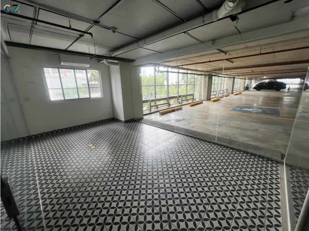 Industrial style commercial unit with glass wall facing parking, patterned tile and natural light at PH Dream Plaza