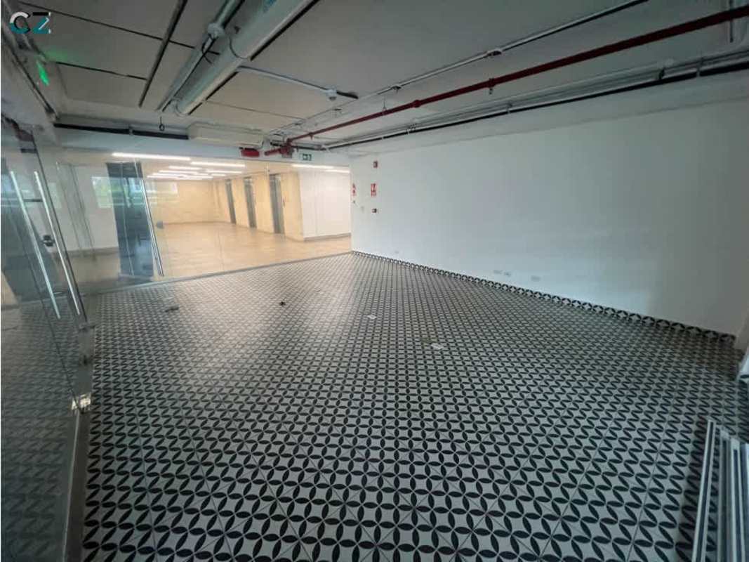 Empty open-plan office space with glass partitions and patterned ceramic flooring at PH Dream Plaza