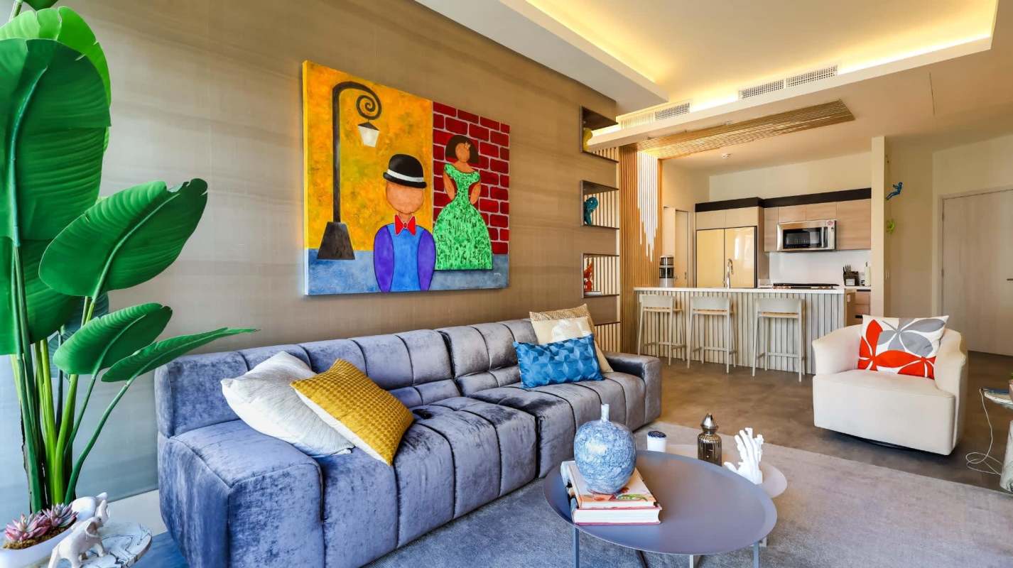 Open living room with colorful art, kitchen island, modern design in PH Ocean House Santa María Panama
