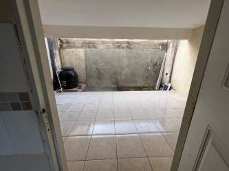 Outdoor patio area tiled with concrete walls water tank utility zone villa rosario capira panama