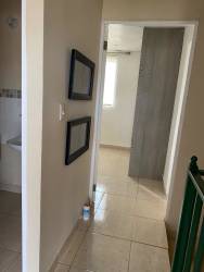 Minimalist bedroom with window, tiled floor, AC unit, and blue sleeping pad Villa Rosario Capira Panama