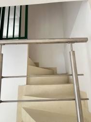 Interior spiral staircase metal railing leading to second floor in rental house Villa Rosario Capira Panama