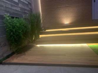 Entry hall with staircase, gray walls and white railing at Costa Verde house for rent in Panama