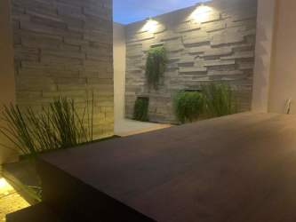 Stylish patio with wood features and vertical greenery in Costa Verde house Panama