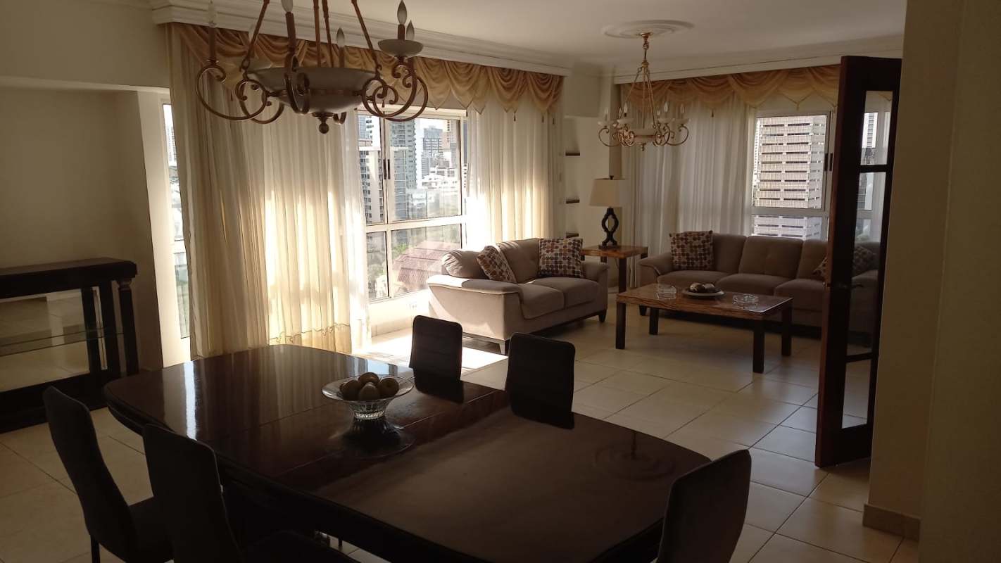 Elegant living and dining space with panoramic windows at Victoria Tower Obarrio Panama City apartment for sale