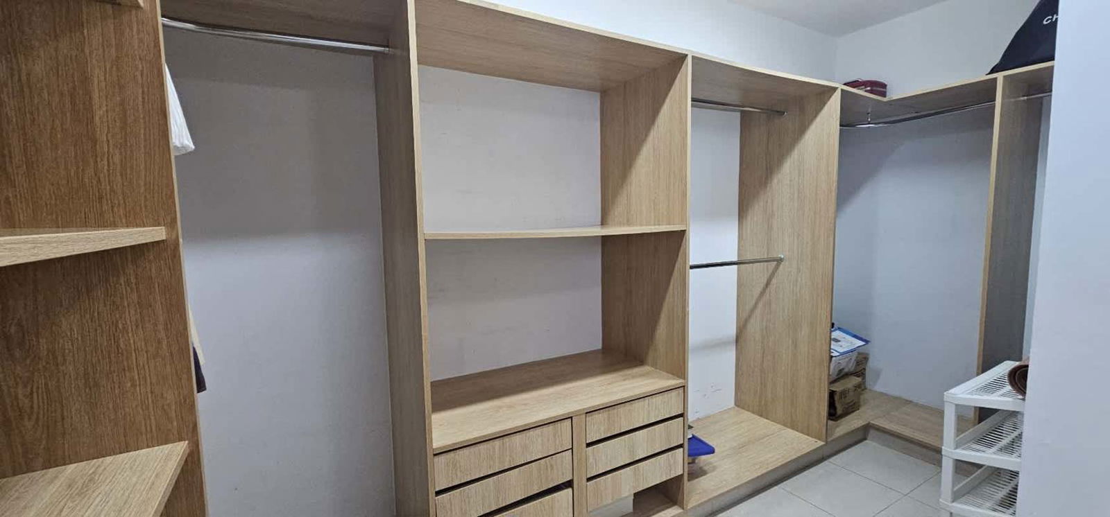 Spacious walk-in closet with built-in shelves and drawers in PH Tao Panama City