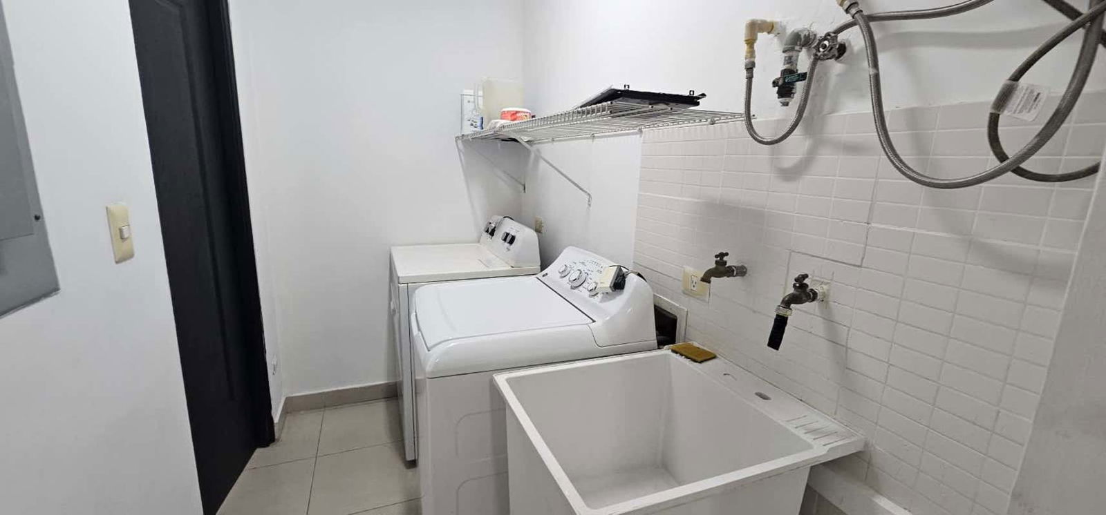 Laundry room with washer dryer hookups and utility sink in PH Tao San Francisco