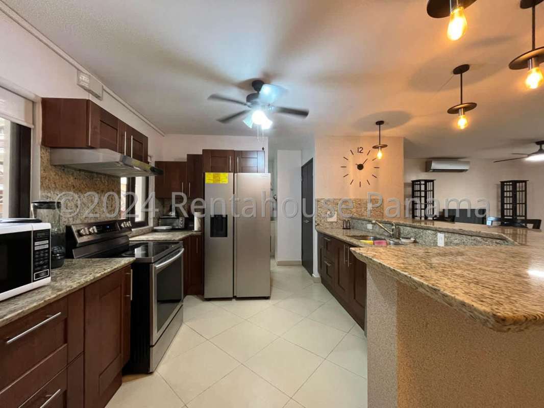 Contemporary apartment kitchen with granite countertops and appliances at Embassy Club Clayton Panama