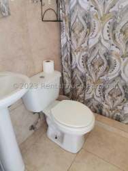 Compact kitchen with window, cabinets, stove and refrigerator Panama