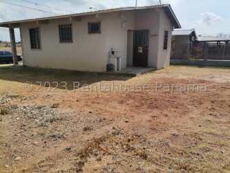 Brick wall enclosed dirt yard with poles for clothes drying Penonomé