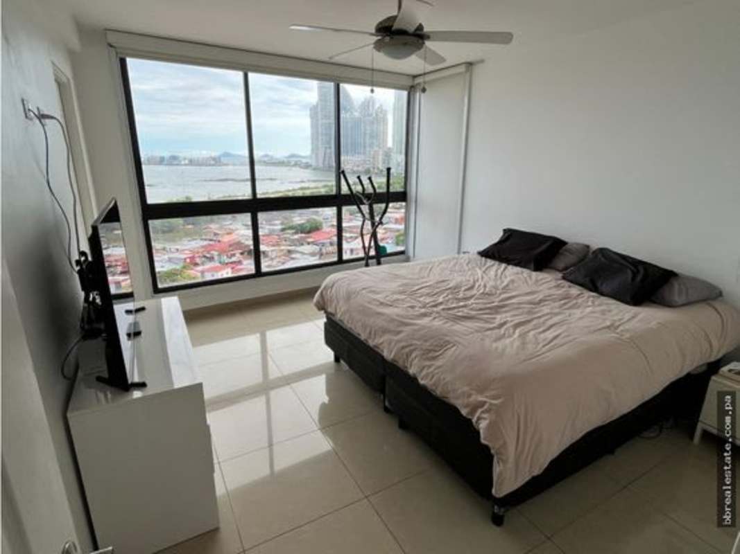 Bright living and dining room with tiled floors, large windows, AC, modern lighting in PH San Francisco Bay Panama