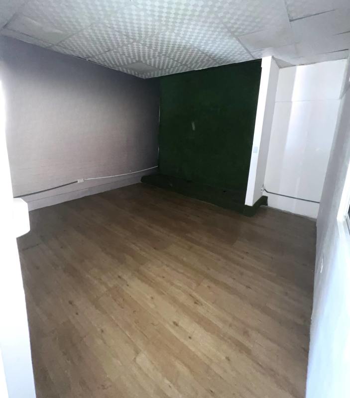 Commercial office detail with green accent wall wood flooring and raised platform Bethania Panama