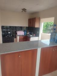 Apartment kitchen granite countertops black tile backsplash in Las Tablas building