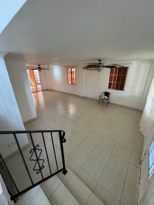 Spacious covered backyard terrace with ceiling fans, stone accent wall in Altos de Santa Maria Panama City