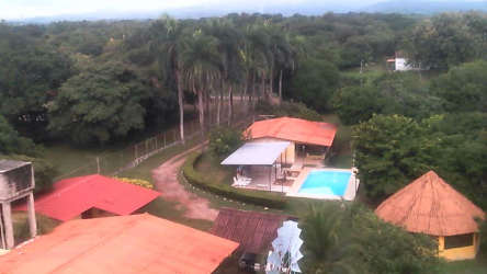 Exterior rustic house with veranda red tile roof lush gardens at Playa Nueva Gorgona Panama