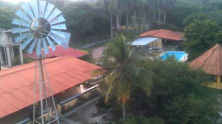 Aerial rural estate pool windmill farmhouse lush greenery Playa Gorgona beach Panama