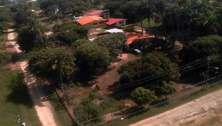 Aerial multiple houses large lot trees fencing beach real estate Nueva Gorgona Panama