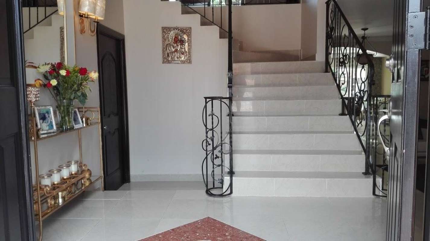 Contemporary kitchen marble countertops red chairs luxury house Costa del Este Panama