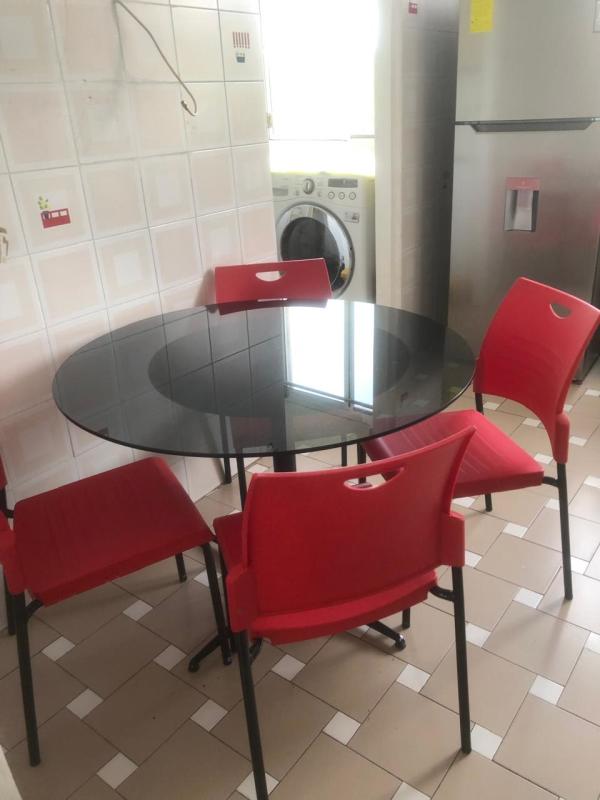 Traditional dining room with wood table and marble floors in PH Vista del Dorado