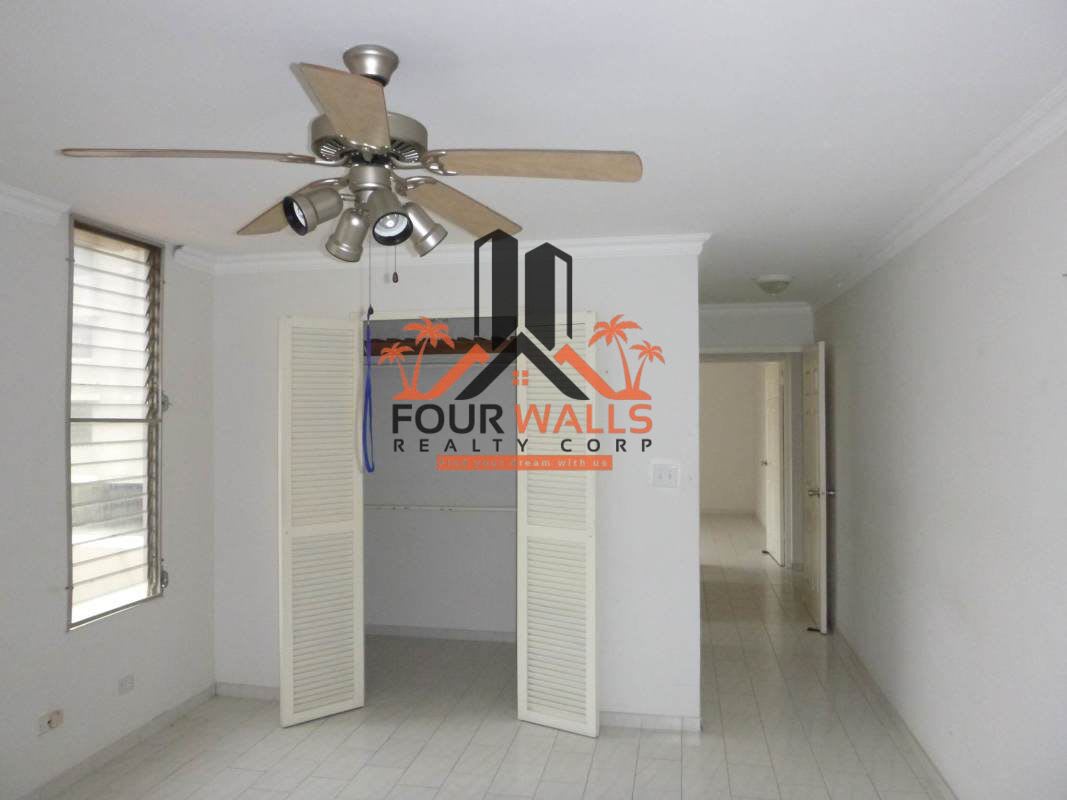 Functional apartment kitchen with white cabinets and tiled backsplash PH Ocean View Panama