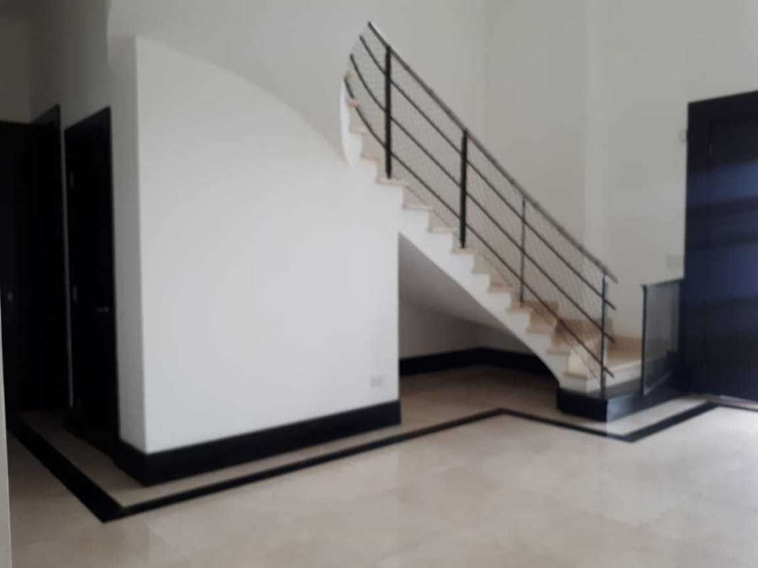 Minimalist interior entry with staircase, marble floors Costa del Este home Panama