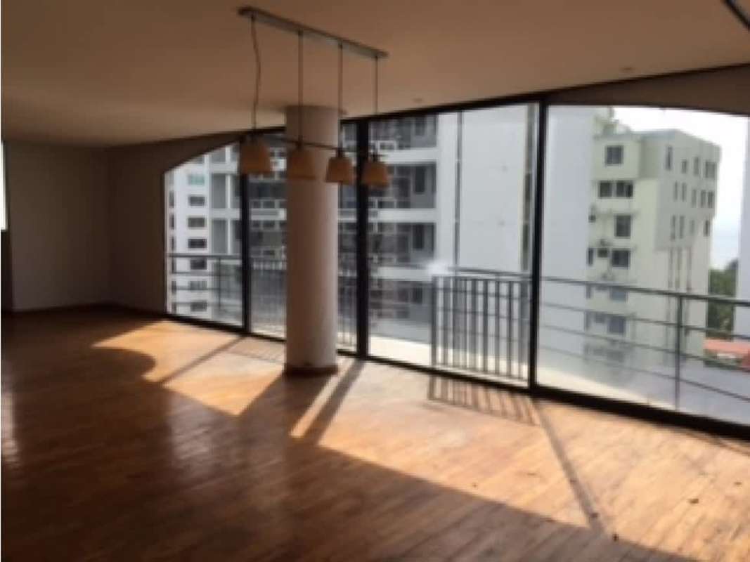 Spacious unfurnished living area with wood floors curved glass wall PH La Caleta 6 Panama