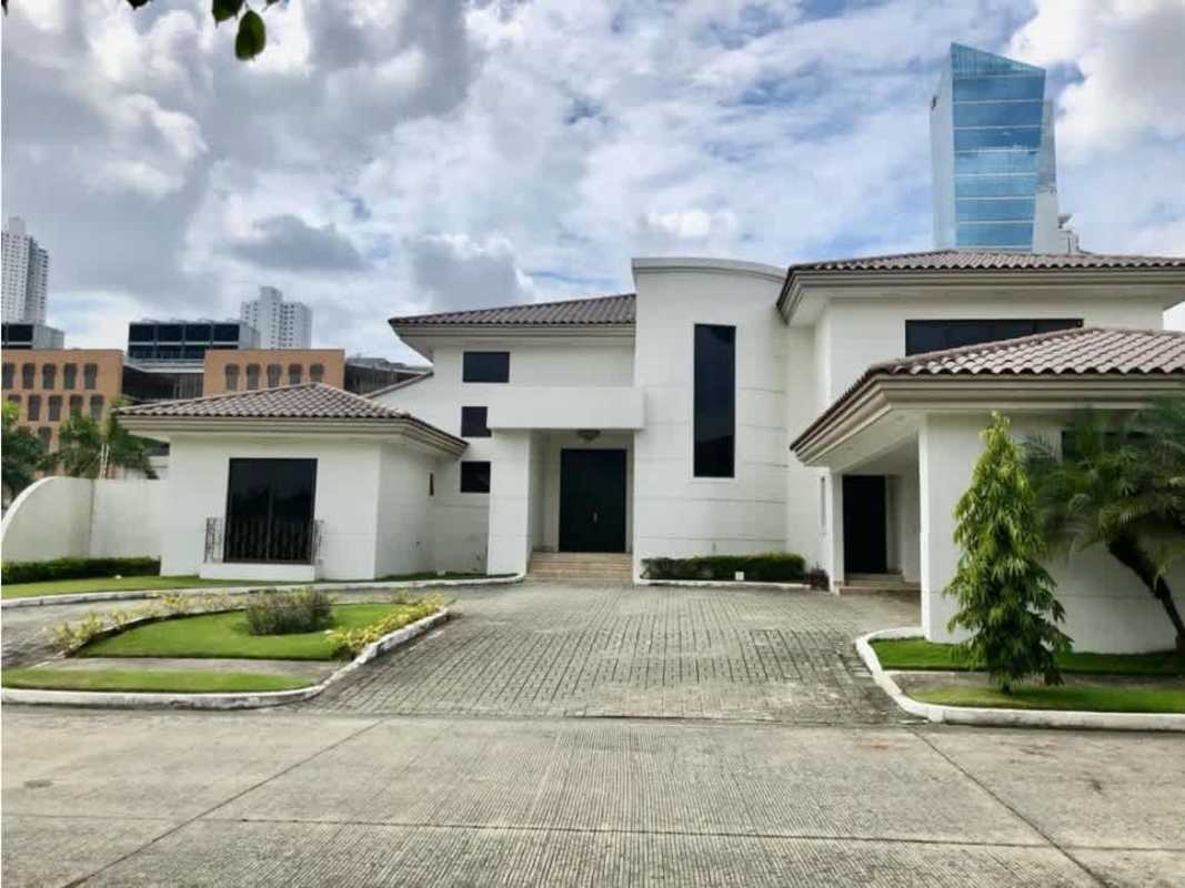 Luxury house entrance with large driveway, green lawn and palm trees Costa del Este Panama