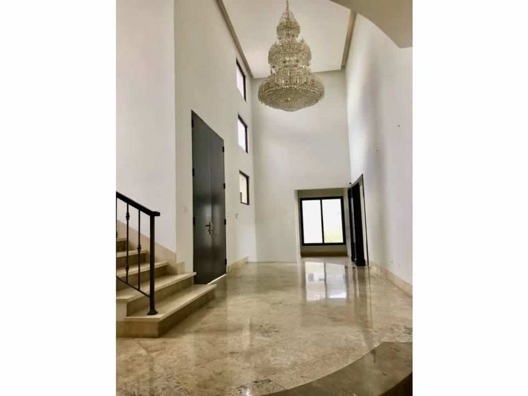 Entry hall with chandelier, marble flooring, wrought iron staircase in luxury Costa del Este home