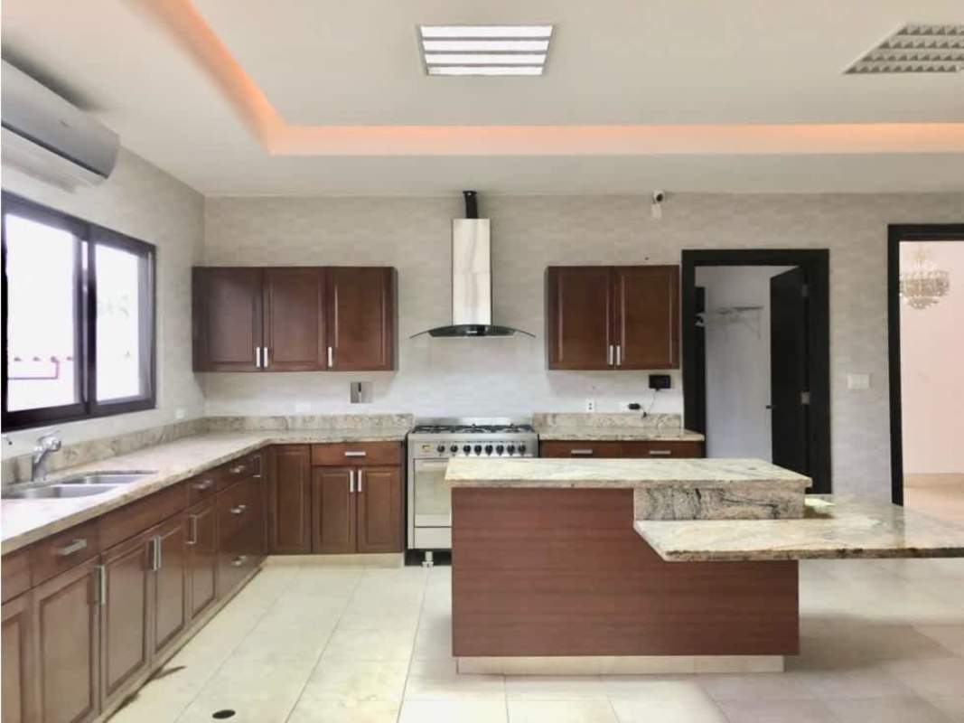 Living space with marble floor, double height, grid window at PH Paseo del Parque