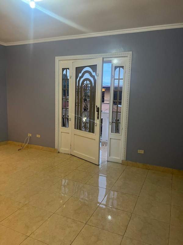 Empty living room with ceramic tiles double glass doors in duplex house San Antonio Panama City