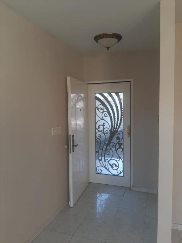 Kitchen with white cabinets and double sink in Altos de Las Praderas San Antonio Panama