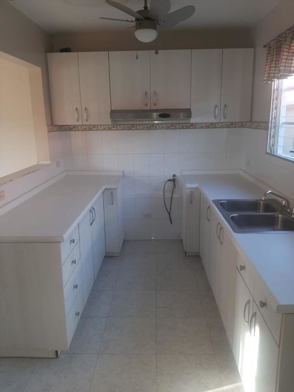 Entryway with decorative glass and ironwork door in Altos de Las Praderas house Panama