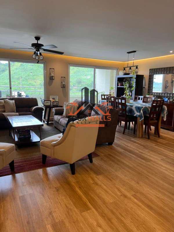 Spacious living and dining area with large windows and balcony access in PH Altamira Gardens Ancón Panama
