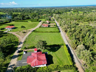 Aerial land view showing ocean horizon, large plots, and natural landscape near Pedasí