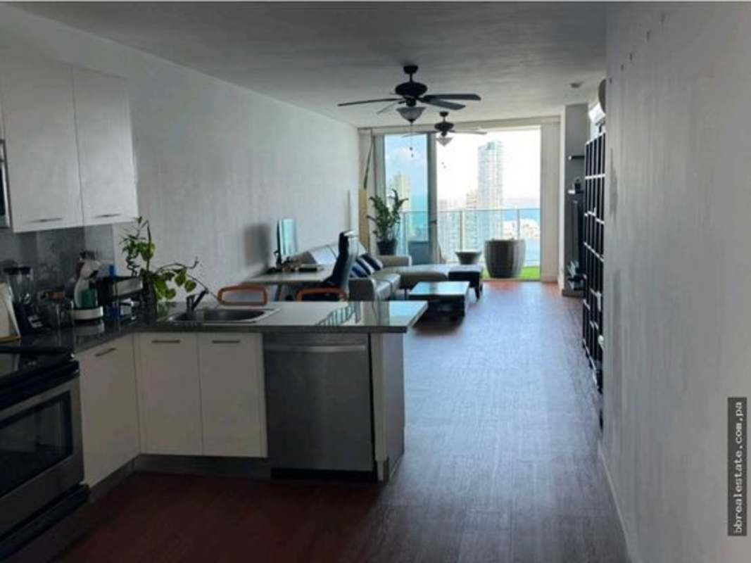 Open kitchen with granite countertops, stainless steel appliances and orange bar stools PH White Tower Panama