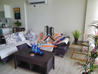 Bright living room with large windows facing Pacific Ocean in Tower Sanctuary condo Playa Caracol Panama