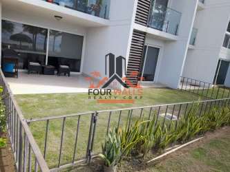 Modern condominium exterior with private patio, fenced garden, sliding glass doors Punta Chame Panama