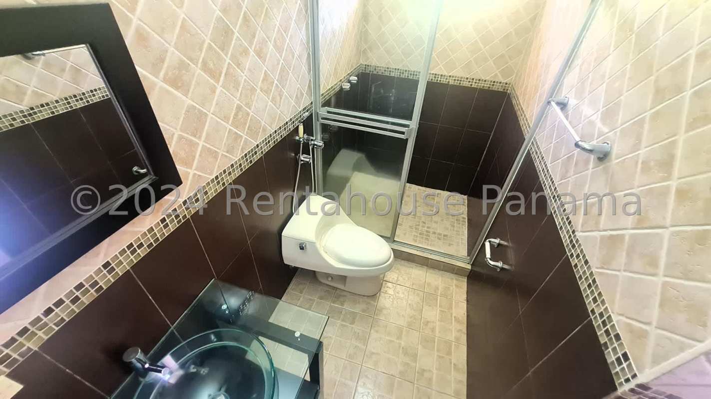 Traditional hallway with carved wooden closets, arched window Costa Dorada Panama