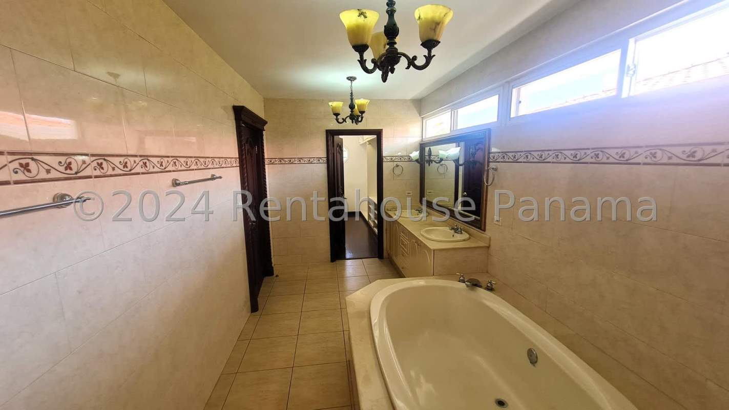 Community entrance sign with water fountain and lush landscaping in Costa Dorada Costa del Este Panama