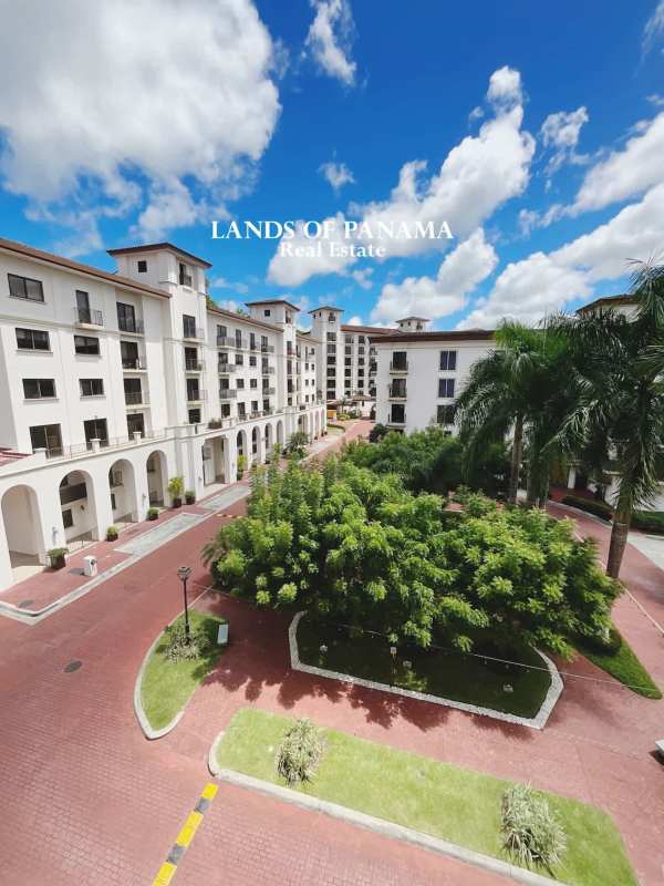 White Mediterranean-style residential towers with archways and gardens in Embassy Village Panama