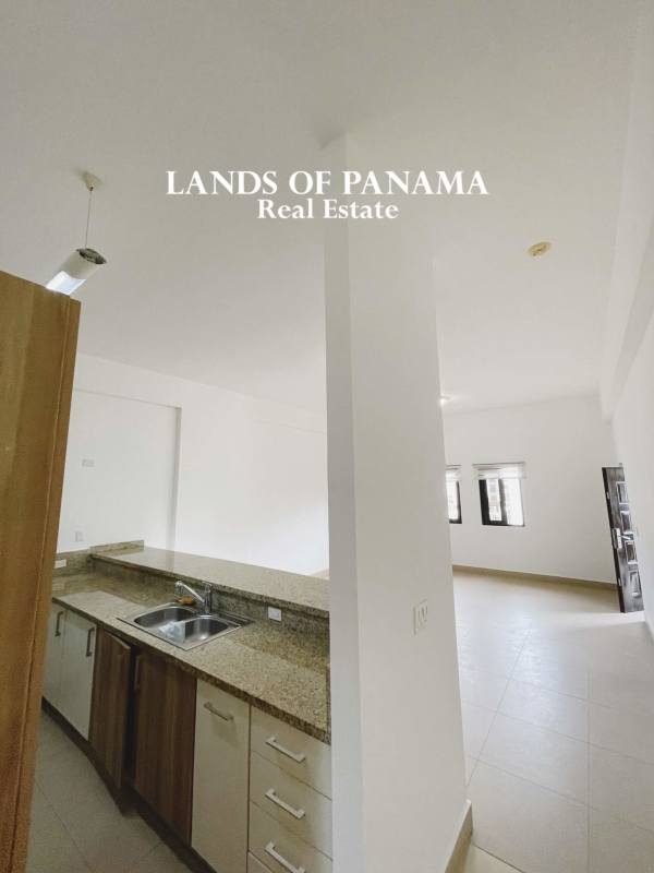 Open kitchen with granite countertops, appliances and porcelain floor in PH Embassy Village Albrook Panama