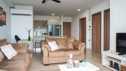 Living and kitchen area leading out to balcony with Pacific view Royal Palm