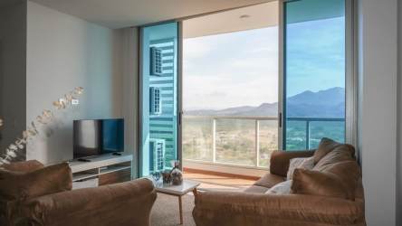 Living space with glass doors opening to balcony ocean view Royal Palm Gorgona Panama