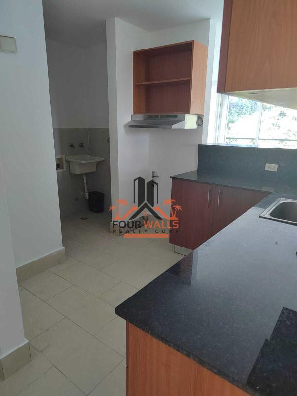 Modern kitchen with granite countertops and wood cabinets at PH Met View Panama City