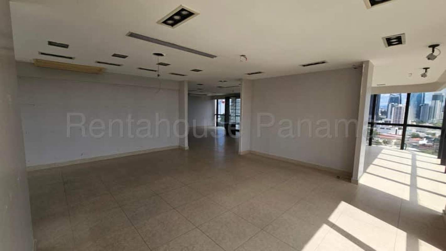 Spacious modern office in BBVA Tower with large floor-to-ceiling windows overlooking ocean and skyline