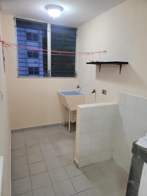 Minimalist open kitchen with breakfast bar, fridge space, and tile floor in PH Morada del Sol Pueblo Nuevo